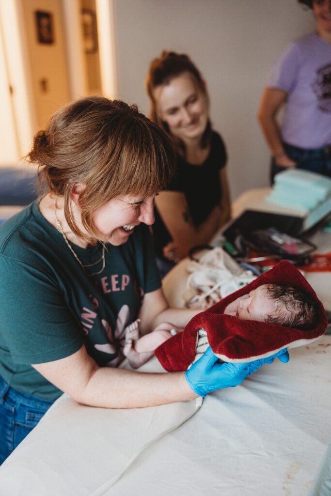 Midwife Kristen Shook providing gentle home birth care in Traverse City, Northern Michigan.