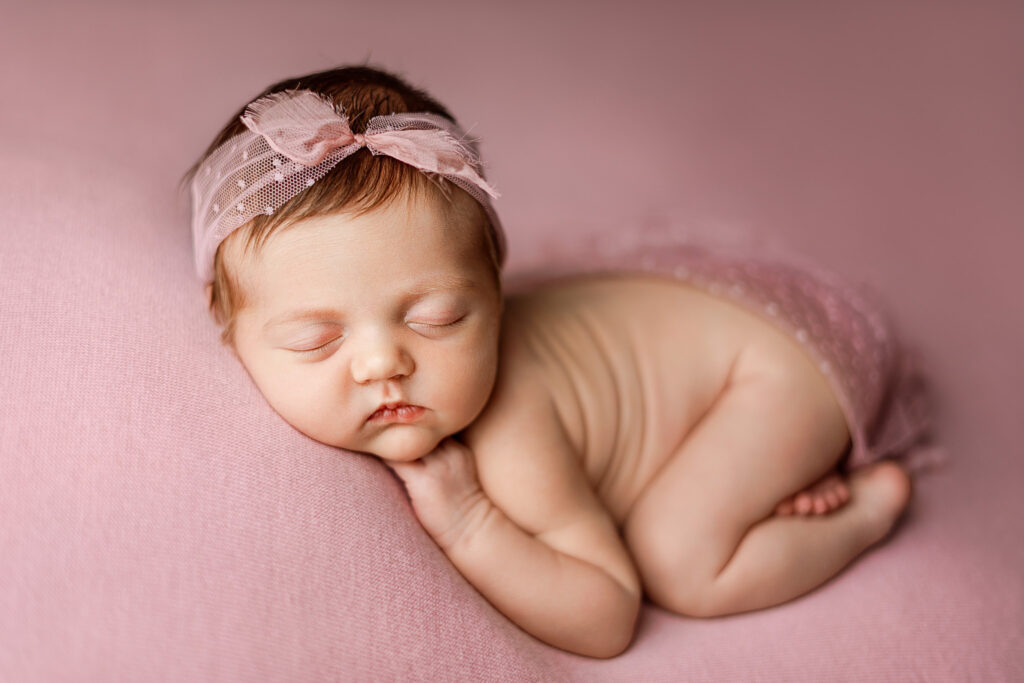 Newborn wrapped in soft blanket during full-service photography session in East Jordan studio