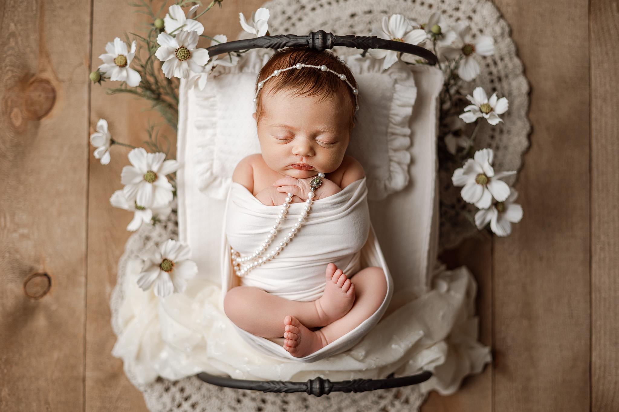 Full-service newborn photographer guiding parents through stress-free photo experience